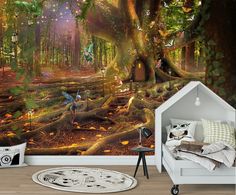 a room with a large wall mural in the shape of a tree and fairy figures