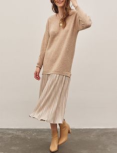 Updating a vintage silhouette with soft detail, the Luisa dress artfully combines the perfect slouchy, longline sweater with a sweeping plisse skirt at the hemline. A soft + plush biscotti knit and crinkle drop-waist skirt in shimmery champagne - this elevated sweater dress is ideal for holidays with suede ankle boots or lifted by a nude heels. 74% acrylic, 22% polyester, 4% spandex 100% polyester lining Unlined top, lined skirt Dropped shoulders Pullover fit Very relaxed fit, consider sizing do Twofer Top, Dress With Ankle Boots, Skirt And Sweater, Twofer Sweater, Longline Sweater, Drop Waist Skirt, Metallic Pleated Skirt, Metallic Skirt, Baby Bottoms