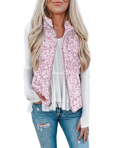 a woman with blonde hair wearing a pink floral vest