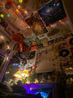 the ceiling is decorated with many colorful lights and pictures hanging from it's walls