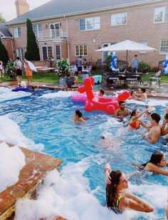 several people are in the pool with an inflatable float