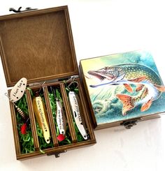 an open box containing several different types of fishing lures and other things in it