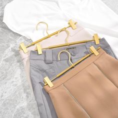 This elegant matte golden color fashionable design, decorate your closet and make a uniform look. Strong enough to weigh heavier pants, skirts, slacks and trousers. Slim body with length 12.2 inch could be portable when traveling or on business, it doesn't take up much space. Not only can be used for trousers, but also can hold hats, ties, socks, shorts, scarf, poster. Everly Quinn | Everly Quinn Sherral Metal Non-Slip Hangers w / Clips for Skirt / Pants 4.33 H x 12.2 W in pink / yellowMetal in Spring Stretch Gold Pants, Elegant Gold Bottoms For Spring, Gold High Waist Bottoms For Spring, High Waist Gold Bottoms For Spring, Elegant Stretch Gold Bottoms, Gold Pant Hangers, Non Slip Hangers, Hanger Organizer, Hanger Clips