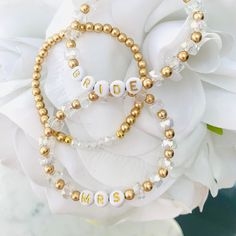 Every Bride loves some sparkle!! Lovin' these sparkle Bride and Mrs. bracelets with white bead/gold letters paired with a matte gold Lucky 7 bracelet. Please indicate size preference and date or name (if you desire to personalize) to be displayed at the time of purchase. These bracelets can be worn alone or stacked with other Mini Me personalized custom bracelets.  💟Please indicate the desired sizing within the customization section. Sizing length is as follows:  Women's small: 6.5 inches Women Bead Bracelet Business, Bride Bracelet, Mama Bracelet, Name Bracelets, Multiple Bracelets, Lucky 7, Miss To Mrs, Custom Bracelet, Clay Bracelet