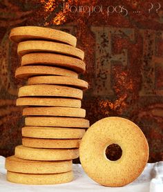 a stack of cookies sitting on top of a table next to a doughnut hole