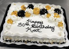 a birthday cake with white frosting and yellow flowers on the top that says happy 30th birthday kat