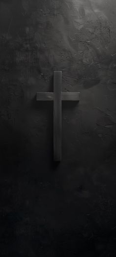 a wooden cross in the middle of a dark room