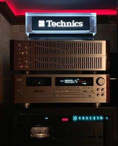 the electronics are stacked on top of each other in front of a sign that says technics