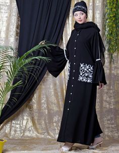 Easy to wear and handle Partywear abaya Classy and elegant Executive formal Abaya Elegant and trendy kaftan for every occasion Loose and elegant trendy fit to all Premium Shine Nida Fabric with rich look Hijab and band shown in the image can be bought separately Fabric: 100% Polyester Crepe ( Matt Finished Nida)Care: Mild machine wash/ hand Cold Wash/ Dry cleanWe request customers to carefully choose the correct size and dress length referring to our size chart Modest Black Kaftan For Eid, Long Abaya With Dabka Work, Black Long Sleeve Khimar With Dabka, Black Floor-length Abaya With Dabka Work, Long Embroidered Abaya For Eid, Traditional Long Sleeve Embroidered Khimar, Traditional Embroidered Long Sleeve Khimar, Embroidered Khimar For Eid, Black Abaya With Dabka For Eid