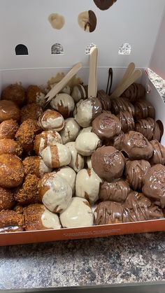 a box filled with lots of different kinds of donuts