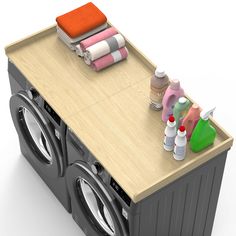 a washer and dryer sitting on top of a wooden table next to each other