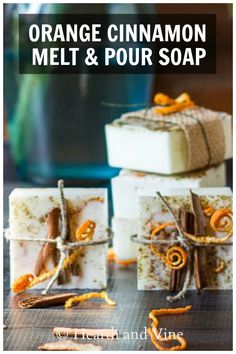 orange cinnamon melt and pour soap on a table next to two bars of soap with cinnamon sticks sticking out of them