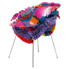 a colorful chair sitting on top of metal legs