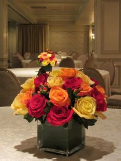 a vase filled with colorful flowers on top of a table