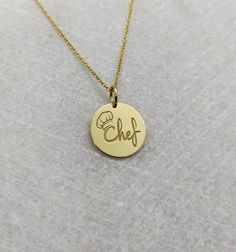 "Chef Necklace - Engraved Chef Charm - Gold Graduation Charm - Gold Cooking Pendant ▪️ A beautiful and clean engraved Chef pendant made out of 14K Solid Real Gold. Available only in yellow gold! Pendant Thickness: 0.65mm Jump Ring inner diameter: 4mm Dimensions - Small - 13x13mm / 0.51 x 0.51 inches Medium - 14x14mm / 0.55 x 0.55 inches Big - 15x15mm / 0.59 x 0.59 inches Necklace Length - You can choose your chain length from 35CM to 50CM. The pendant is available alone without a chain, select \ Gold-tone Pendant Jewelry For Gift, 14k Gold Round Pendant Necklace Gift, Gold Plated Charm Necklaces With Polished Finish For Gift, 14k Gold-tone Necklace For Gifts, Round Gold-tone 14k Gold Charm Necklace, Gold-tone Round Pendant Jewelry Gift, Gold-tone Round Pendant Jewelry For Gifts, Round 14k Gold-tone Charm Necklaces, Round 14k Gold-tone Charm Necklace