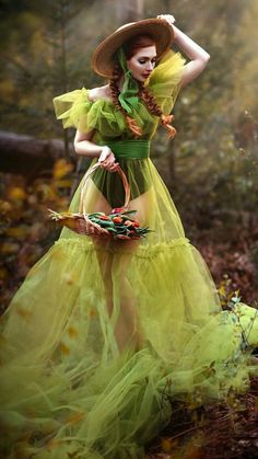 a woman in a green dress and hat holding a basket with candy on the ground