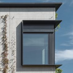 a window on the side of a white building