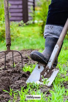 a person digging in the dirt with a shovel and fork on top of their feet