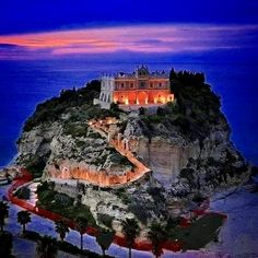 an island with a castle on top at night