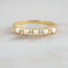 Delicate opal ring, that is perfect for stacking or wearing alone. A true beauty and must have! Sweet, simple, and dainty ring. Perfect for a minimalist look. ☆ Details ☆ * Made of 925 Sterling Silver * Available in 14k Gold Plating, Rose Gold Plating or Rhodium Plated * We use a THICK, DURABLE 14k GOLD plating - for a piece that will last you years to come! * VERY HIGH QUALITY * Lab Created Opals- we use the highest grade for an authentic look * Available in sizes 4, 5, 6, 7, 8, 9, or 10 ✈️READ White Opal Stackable Rings For Promise, White Opal Stackable Promise Rings, Gold Opal Stackable Rings For Wedding, Delicate Adjustable Opal Wedding Ring, Delicate Stackable Opal Ring For Wedding, Dainty Stackable Opal Wedding Ring, Adjustable Stackable Opal Ring For Wedding, Adjustable Opal Birthstone Wedding Ring, Dainty Opal Ring