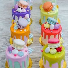 there are four cakes that have different designs on each cake, and one is decorated with colorful icing