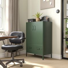 a green cabinet sitting in the corner of a room next to a desk and chair