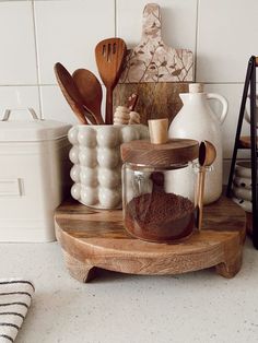 a wooden tray topped with lots of different types of utensils and other kitchen items