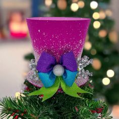 a christmas tree with a purple and blue hat on it