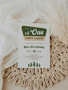 a birthday party card sitting on top of a doily next to a white blanket