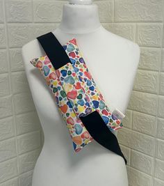 a white mannequin wearing a colorful neck tie