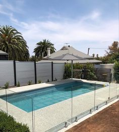 an empty swimming pool with fencing around it