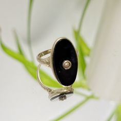 Vintage 30s Victorian style Mourning ring, engraved 14k gold setting with what looks like a teeny tiny diamond set in the middle of black onyx. I believe that the diamond is authentic however the black onyx must have been replaced with a fake (possibly it was damaged). The fake onyx is loose. The Value lies in this Gorgeous vintage gold setting and diamond. fits approx 5 1/4 .1 oz. Classic Oval Hallmarked Enamel Ring, Vintage Sterling Silver Ring With Black Enamel, Vintage Sterling Silver Rings With Black Enamel, Classic Adjustable Black Enamel Rings, Victorian Black Signet Ring Stamped 14k, Victorian Black Oval Rings, Black Oval Enamel Ring For Formal Occasions, Onyx Signet Ring With Black Enamel For Anniversary, Formal Oval Enamel Ring With Black Enamel