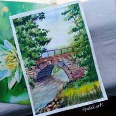 a watercolor painting of a bridge and flowers