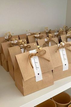 brown paper bags with tags tied to them are sitting on a shelf in a store