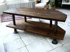 a wooden table sitting on top of a white tiled floor