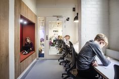 people sitting at desks in an office setting