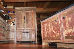 an old wooden cabinet in the middle of a kitchen with wood flooring and walls