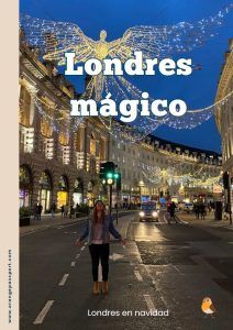 a woman is walking down the street in front of some buildings with lights on them