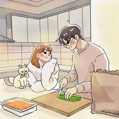 a man and woman are in the kitchen cutting up something with a cat sitting next to them