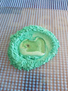 a cake with green frosting in the shape of a heart