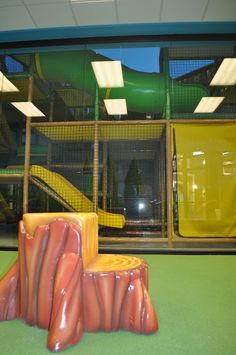 an indoor play area with slide and climbing equipment