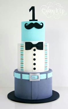 a three tiered cake with a mustache and bow tie