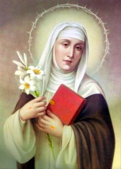 the immaculate mary holding a book and flowers