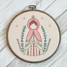 a cross stitch pattern on a wooden hoop