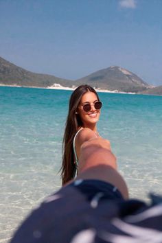 a woman taking a selfie in the ocean