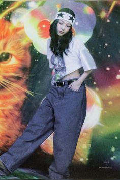 a woman standing in front of a cat wearing headbands and jeans with her hands on her hips