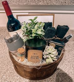 a wooden basket filled with lots of different types of items next to a bottle of wine