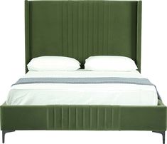 a bed with green headboard and white sheets on top of the bedspread