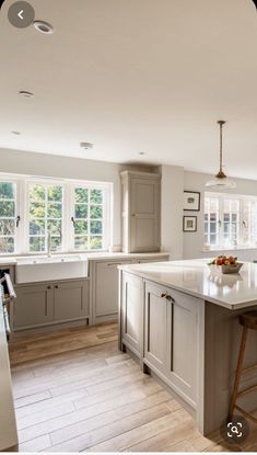 a large kitchen with an island in the middle