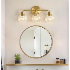 a bathroom vanity with two lights and a mirror